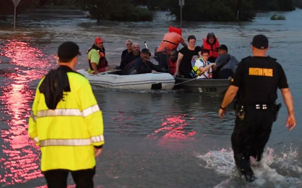 People are rescued from a hotel by boat after Hurricane Harvey caused heavy flooding in Houston,Texas.