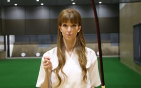 Jess Gerity holding her bow and arrow.