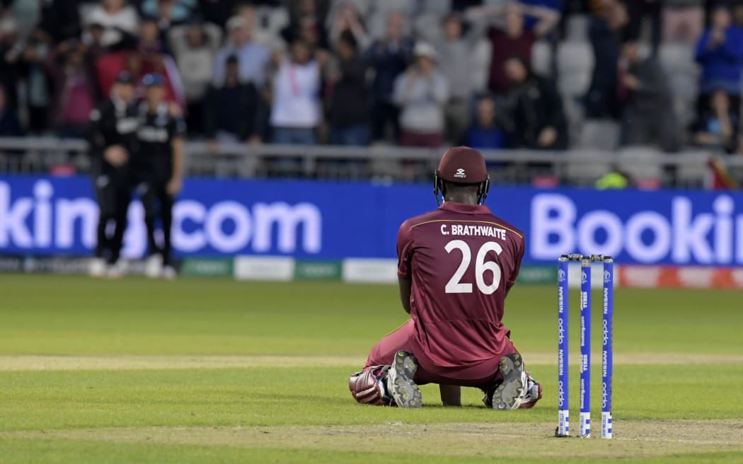 West Indies' Carlos Brathwaite reacts after losing his wicket having fallen short in the run-chase during the 2019 Cricket World Cup group stage match between West Indies and New Zealand at Old Trafford in Manchester.