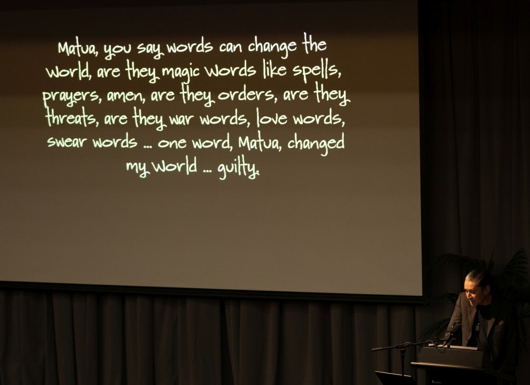 Powerpoint slide at lecture with quote about words changing the world
