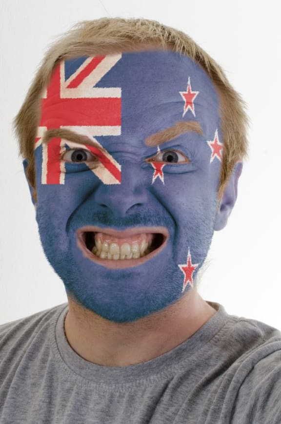 NZ sports supporter with face painted like NZ flag.