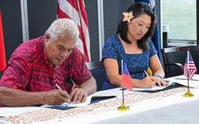 Minister of Police, Honorable Faualo Harry Schuster and U.S. Chargé d’Affaires Noriko Horiuchi signing the U.S. Samoa Bilateral Law Enforcement Agreement addendum.