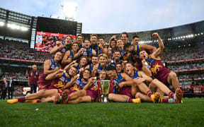 Brisbane Lions players celebrate winning the AFL Grand Final between the Sydney Swans and the Brisbane Lions at the Melbourne Cricket Ground, 2024.