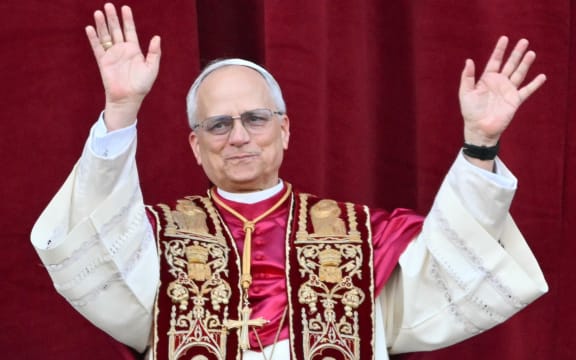 Newly elected Pope Leo XIV, Robert Prevost arrives on the main central loggia balcony of the St Peter's Basilica for the first time, after the cardinals ended the conclave, in The Vatican, on May 8, 2025. Robert Francis Prevost was on Thursday elected the first pope from the United States, the Vatican announced. A moderate who was close to Pope Francis and spent years as a missionary in Peru, he becomes the Catholic Church's 267th pontiff, taking the papal name Leo XIV. (Photo by Alberto PIZZOLI / AFP)