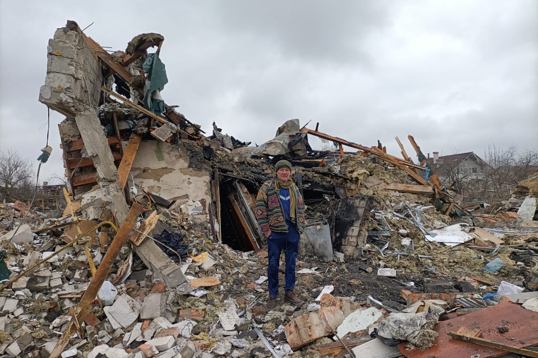 A Ukrainian man stands in the rubble in Zhytomyr on March 02, 2022, following a Russian bombing the day before. The shelling killed at least 3 and injured nearly 20 according to locals and authorities, destroyed a local market and at least 10 houses.
