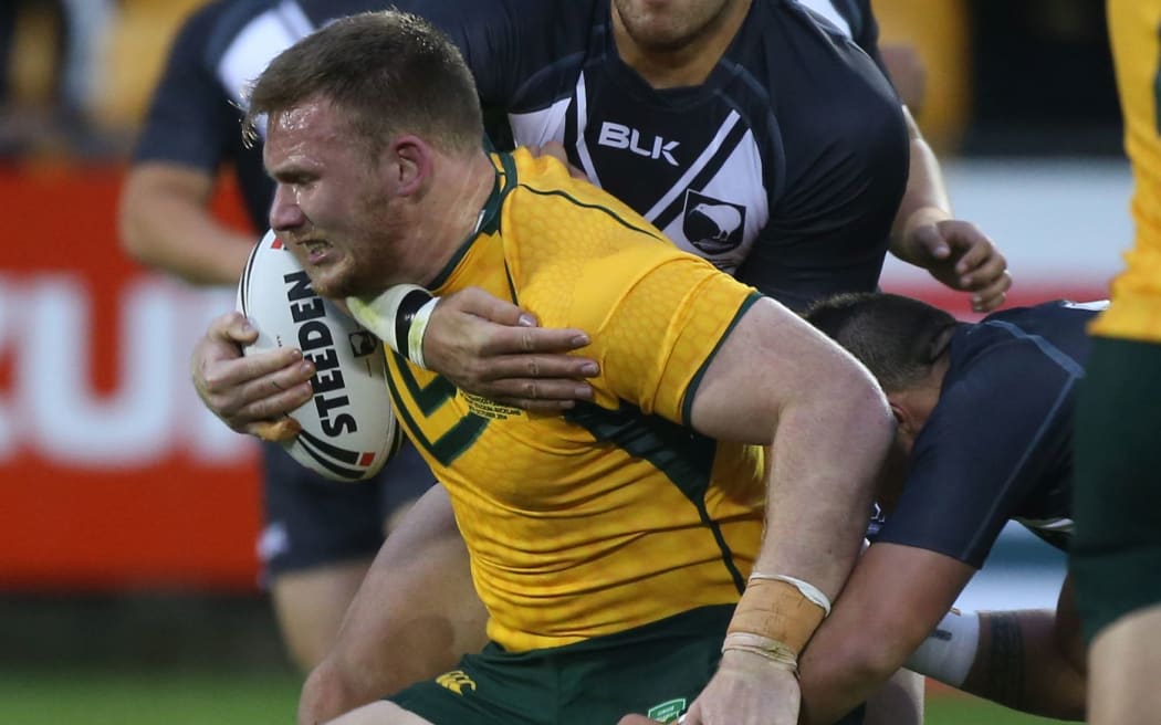 Matt Lodge carries the ball for the Junior Kangaroos against the Junior Kiwis in 2014.