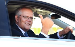 Australian Prime Minister Scott Morrison drives a hydrogen-powered car around a Toyota test track in Melbourne on November 9, 2021, after the government's launch of it's Future Fuels strategy. (Photo by William WEST / AFP)