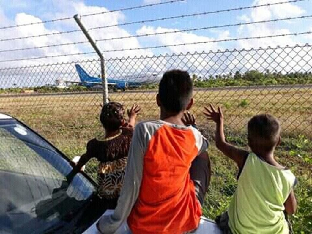 Eritara Kaierua's children wave goodbye to their father as he embarked on his last observer mission.