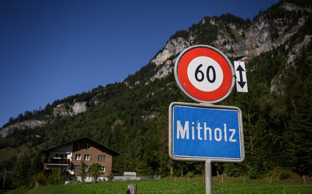 A picture taken on September 24, 2021 shows the entrance to the Swiss village of Mitholz. The tiny Swiss village of Mitholz will have to be evacuated from 2025 to allow the cleaning of an old underground ammunition depot built by Swiss army during the World War II, an operation that will take about ten years, the authorities announced on September 23, 2021. In 1947, some of the roughly 7,000 gross tons of ammunition stored there exploded, killing nine people nearby. About 3,500 tons of raw ammunition still remain in the rubble of the facility and in the scree. (Photo by Fabrice COFFRINI / AFP)