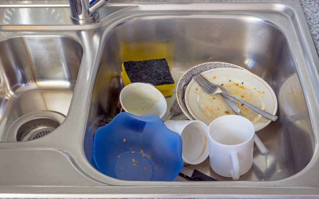 A small pile of dirty dishes in a kitchen sink