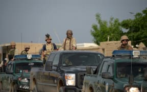 Afghan security personnel arrive at the site of an attack on an army compound in Dihdadi District of Balkh province on April 21, 2017.