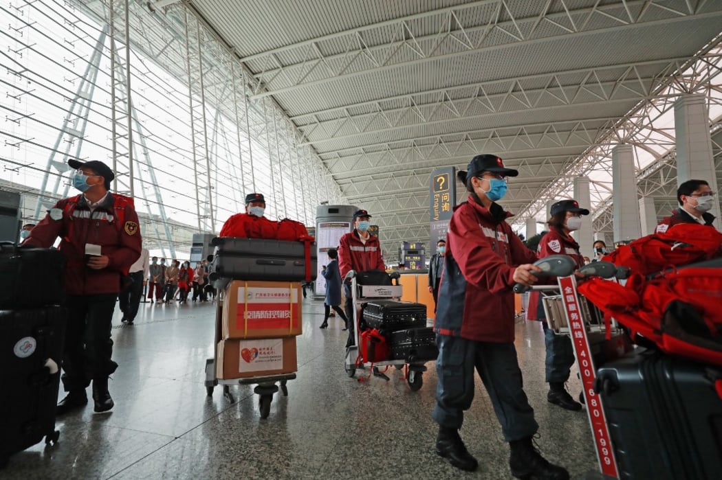 (200321) -- GUANGZHOU, March 21, 2020 (Xinhua) -- Members of Chinese anti-epidemic expert team to Serbia walk to the boarding gate at Guangzhou Baiyun International Airport in Guangzhou, capital of south China's Guangdong Province, March 21, 2020.