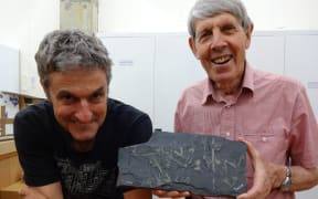Palaeontologists James Crampton, left, and Roger Cooper with a slab of shale with several graptolites.