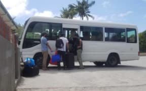 Asylum seekers board a bus at Granville Hotel.