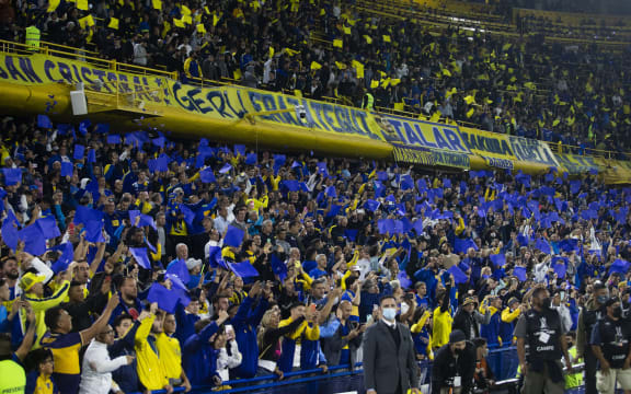 Fans of Boca Juniors cheer on their team at La Bombonera Stadium.