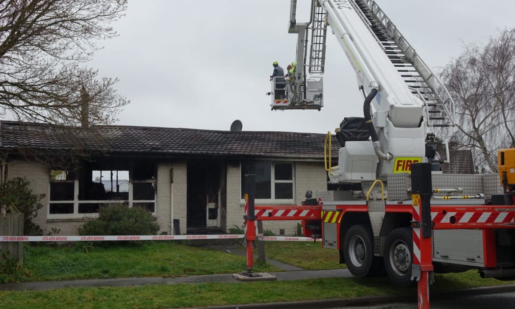A fire service crew at the scene of the Parklands house fire in Christchurch.