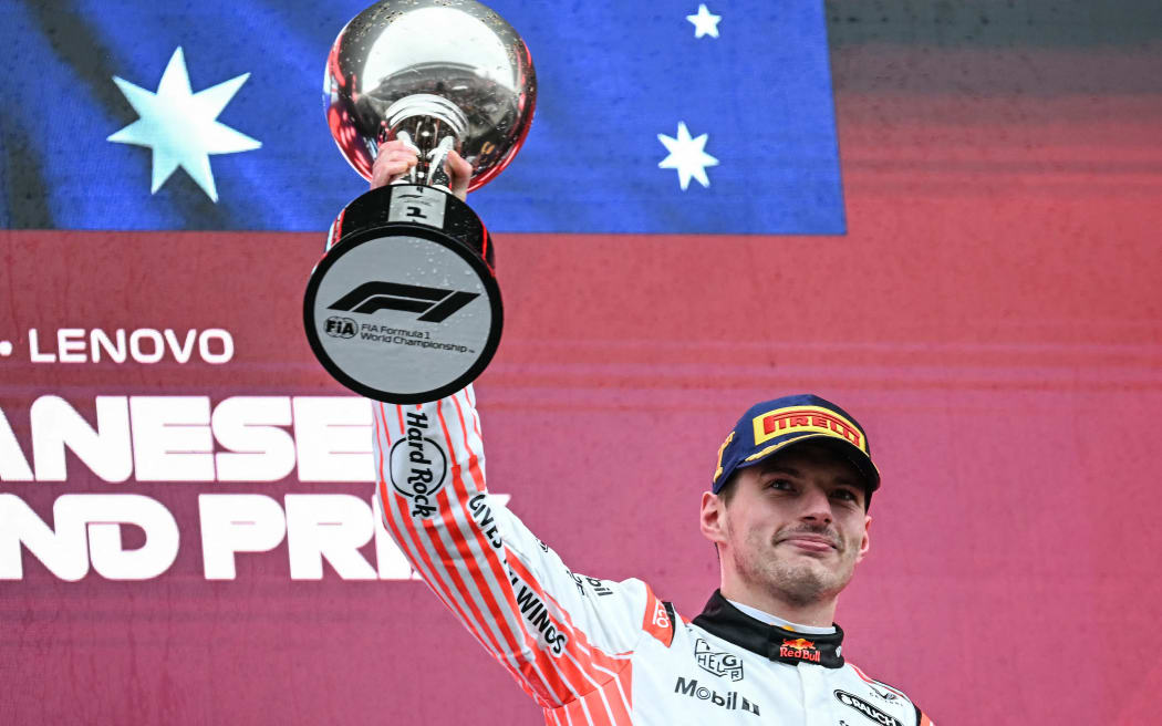 Max Verstappen lifts the trophy after winning the Japanese Grand Prix, 6 April 2025.