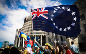 The Cook Islands flag is waved outside Parliament during the strike for climate change in Wellington September 2019