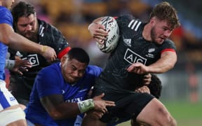 Alex Nankivell (R) of the Maori All Blacks makes a strong run during the rugby Test match with Samoa in Auckland on July 3, 2021.