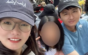 Jia Fan (left), Jun Jiang (right) and their daughter.