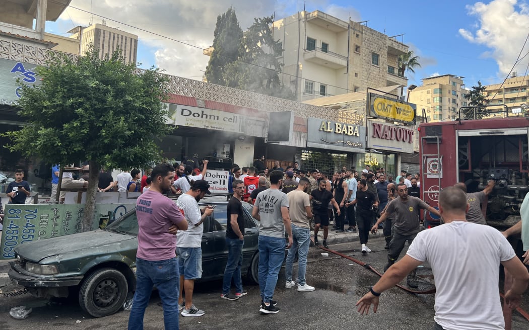 Firefighters put out flames at the scene of a reported device explosion in Saida in southern Lebanon on 18 September 2024.