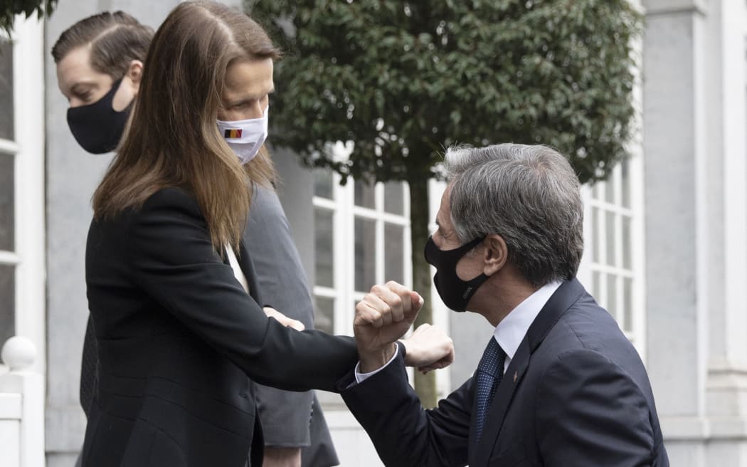 US Secretary of State Antony Blinken (R) is greeted with an elbow bump by Belgium's Foreign Minister Sophie Wilmes at the Egmont Palace in Brussels on March 25, 2021. -