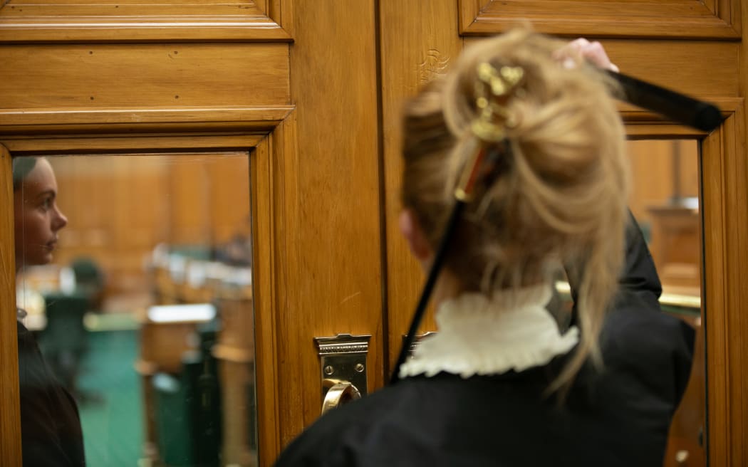 Usher of the The Black Rod, Sandra McKie raps the doors of the debating chamber to open CYP