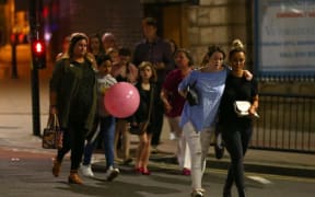 Police escort members of the public from the Manchester Arena on Tuesday.