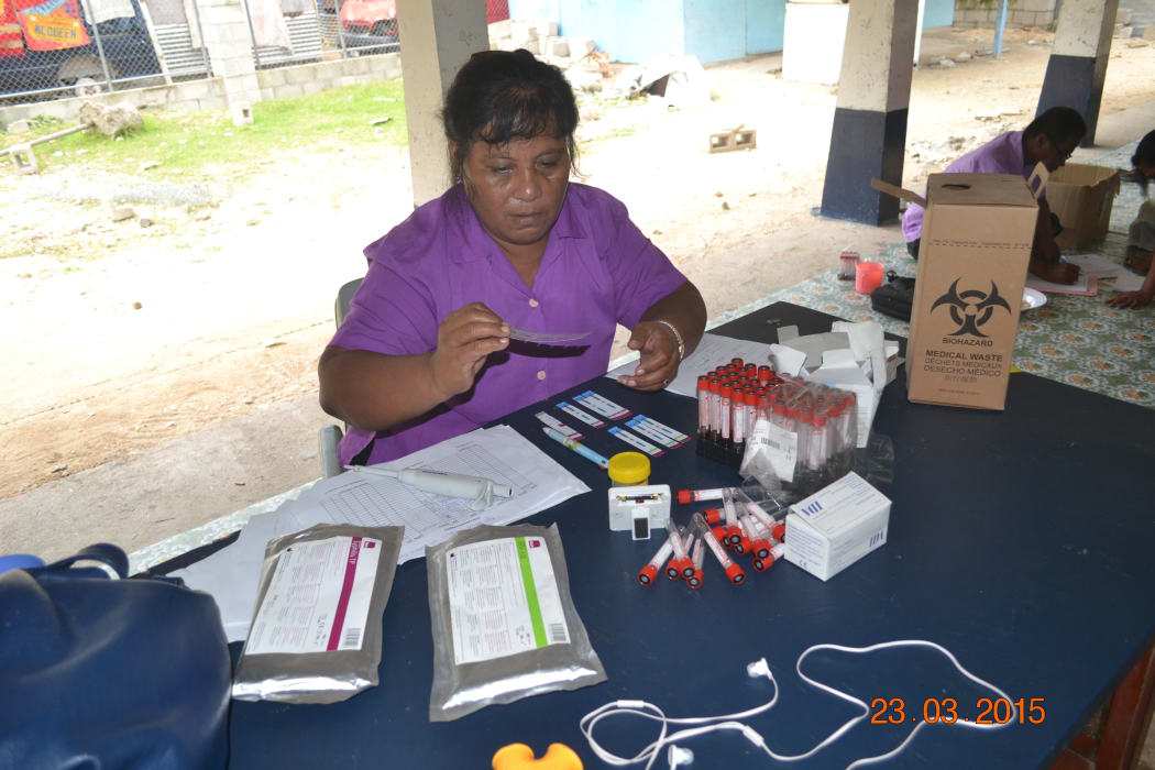 Lab technologist in Kiribati doing HIV blood tests.
