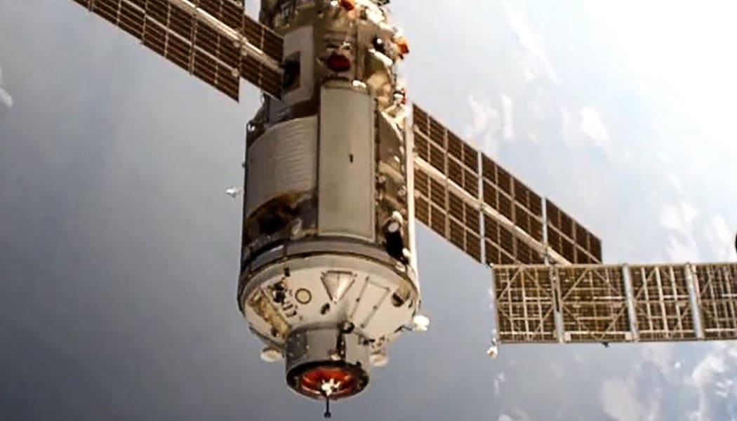 This handout photograph taken and released by the Russian Space Agency Roscosmos on July 29, 2021, shows the Russian Multipurpose Laboratory Module "Nauka" (Science) docking to the International Space Station (ISS).