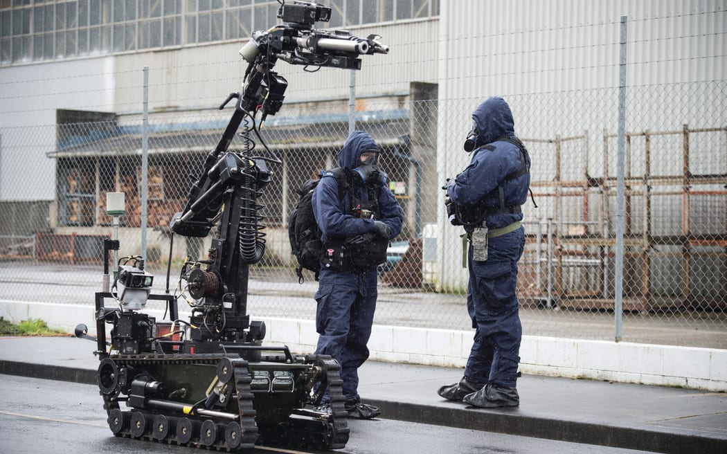 New Zealand Army bomb disposal assistance personnel and remote disposal vehicle.