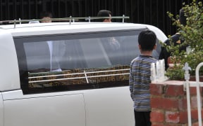 The video mentions Numan Haider who was shot dead last September, the picture shows his body leaving the Afghan Mosque of Victoria.