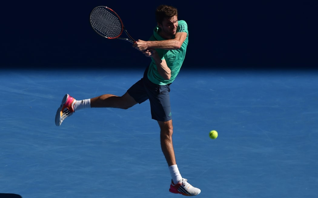 France's Gilles Simon returns against Serbia's Novak Djokovic during their men's singles game on day seven of the 2015 Australian Open in Melbourne, January 24, 2016. AFP PHOTO / PAUL CROCK