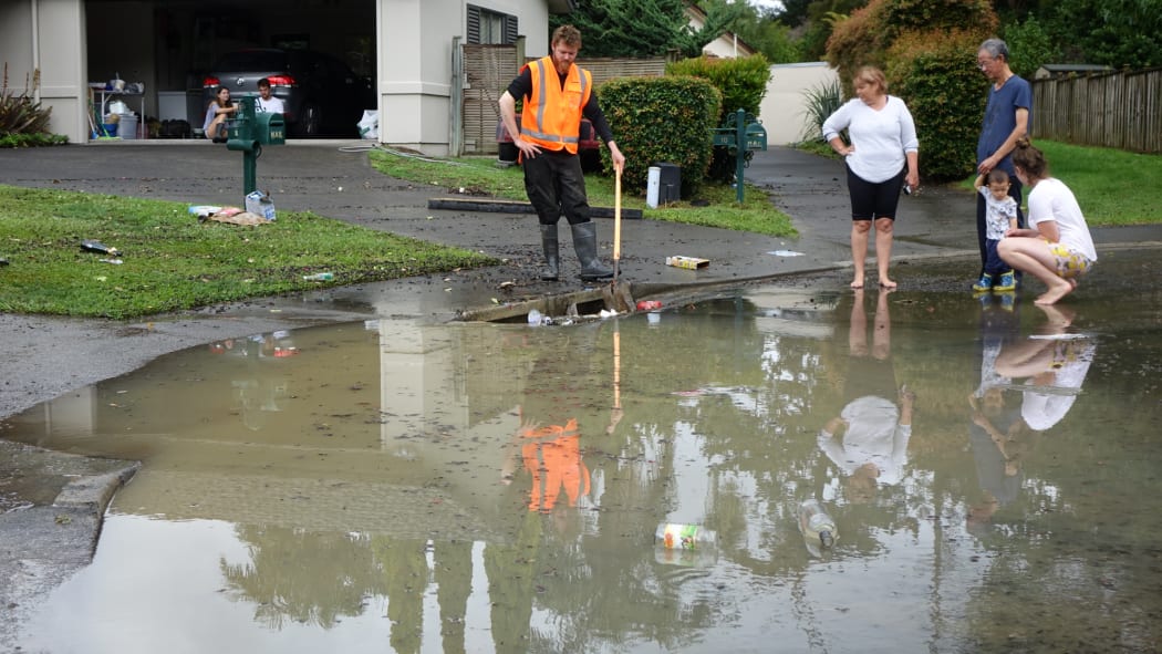 Residents of Sucklings Lane in Rosedale drain their flooded cul-de-sac which was waist high earlier this morning.