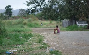 Aimless youth: a young Papua New Guinea man sits on the ground in Kwikila.