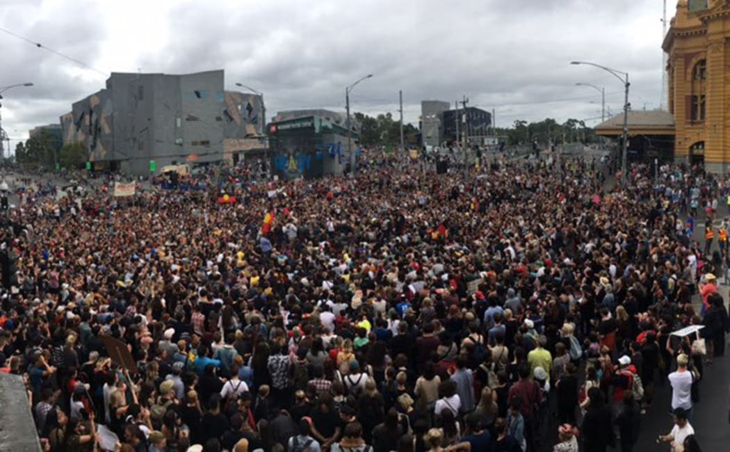 A crowd gathers outside Melbourne's Flinders Station to protest the date of Australia Day.