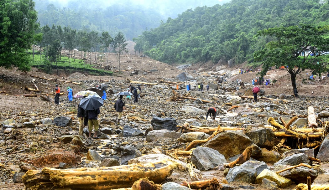 Volunteers, local residents and members of National Disaster Response Force (NDRF) search for survivors in the debris left by a landslide at Puthumala at Meppadi in the Wayanad district of the Indian state of Kerala.
