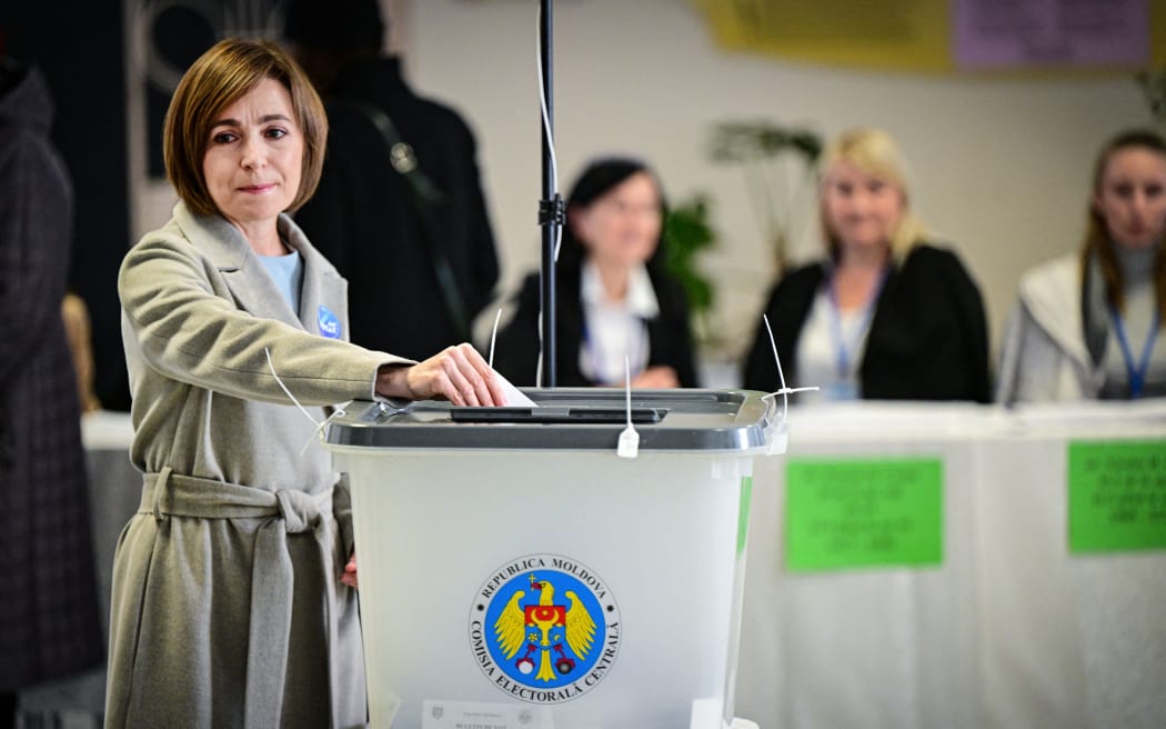 Current Moldova's President and candidate Maia Sandu casts her vote for the presidential election at a polling station in Chisinau November 3, 2024. - Moldova's pro-EU President Maia Sandu is facing Alexandr Stoianoglo, whom she fired as prosecutor general in 2023, in a tense presidential election on November 3, 2024 as the  vote is seen as key to determining whether the ex-Soviet republic sandwiched between Ukraine and as the EU will continue on a pro-European path, with fears of Russian interference looming large. (Photo by Daniel MIHAILESCU / AFP)