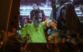 Hostage Tal Almog-Goldstein stands in a bus transporting him to an army base in Ofakim in southern Israel after he was released by Hamas on 26 November 2023.