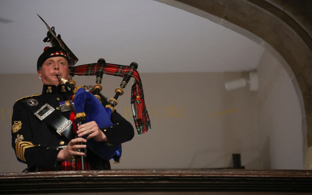 A piper from the Royal Regiment of Scotland plays on the day of the state funeral and burial of Britain's Queen Elizabeth, at Westminster Abbey in London on 19 September 2022.