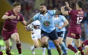 New South Wales' Andrew Fifita brushes off Queensland defenders.