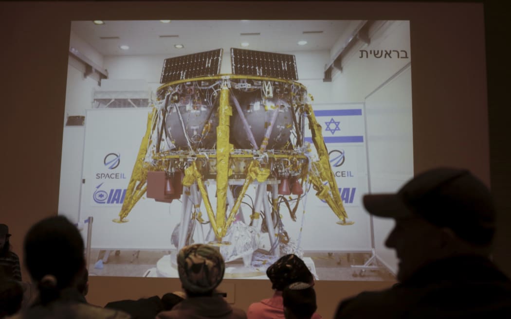 People watch the live broadcast of the SpaceIL spacecraft as it lost contact with Earth in Netanya, Israel.