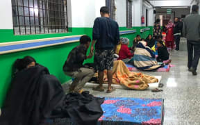 Survivors are seen at a corridor of the Jajarkot district hospital in the aftermath of an earthquake in Jajarkot on November 4, 2023. More than 60 people were killed when a shallow 5.6-magnitude earthquake hit a remote pocket of Nepal, officials said early on November 4. The tremor hit the far west of the Himalayan country late Friday and was measured by the US Geological Survey at just 18 kilometres (11 miles) deep. (Photo by Balkumar Sharma / AFP)