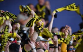 Phoenix fans hold up their scarfs during an A-League match.