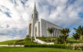 Native landscaping surrounds the temple
