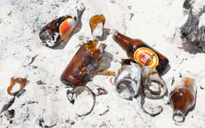 Mount Locals are having to pick up broken glass and rubbish on the beach from parties.