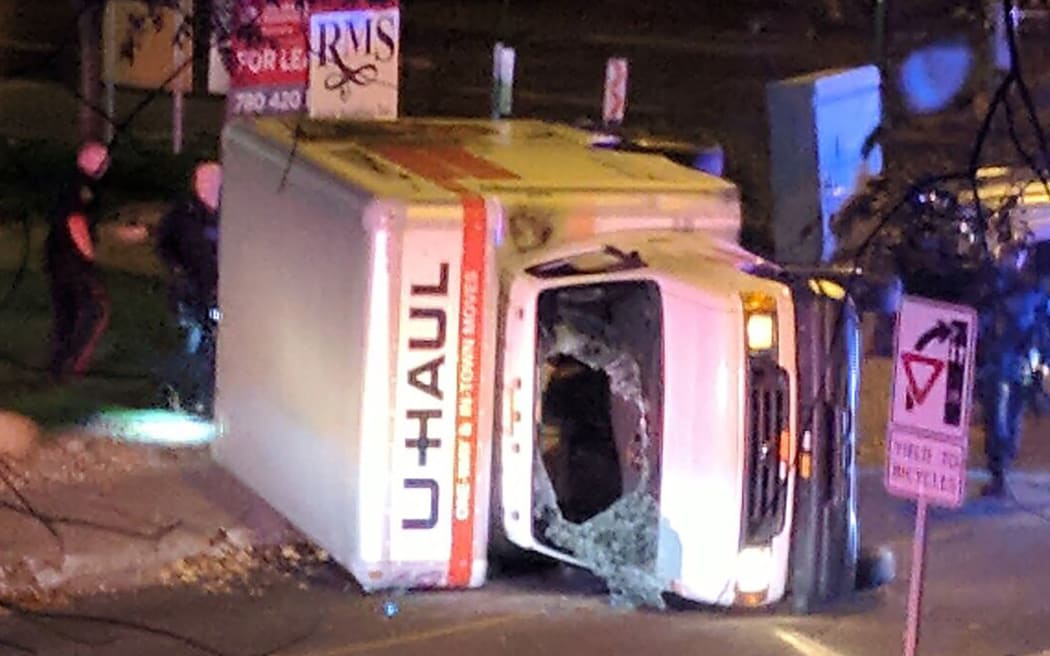 A rental truck lies on its side in Edmonton, Canada, on October 1, 2017, after a high speed chase.