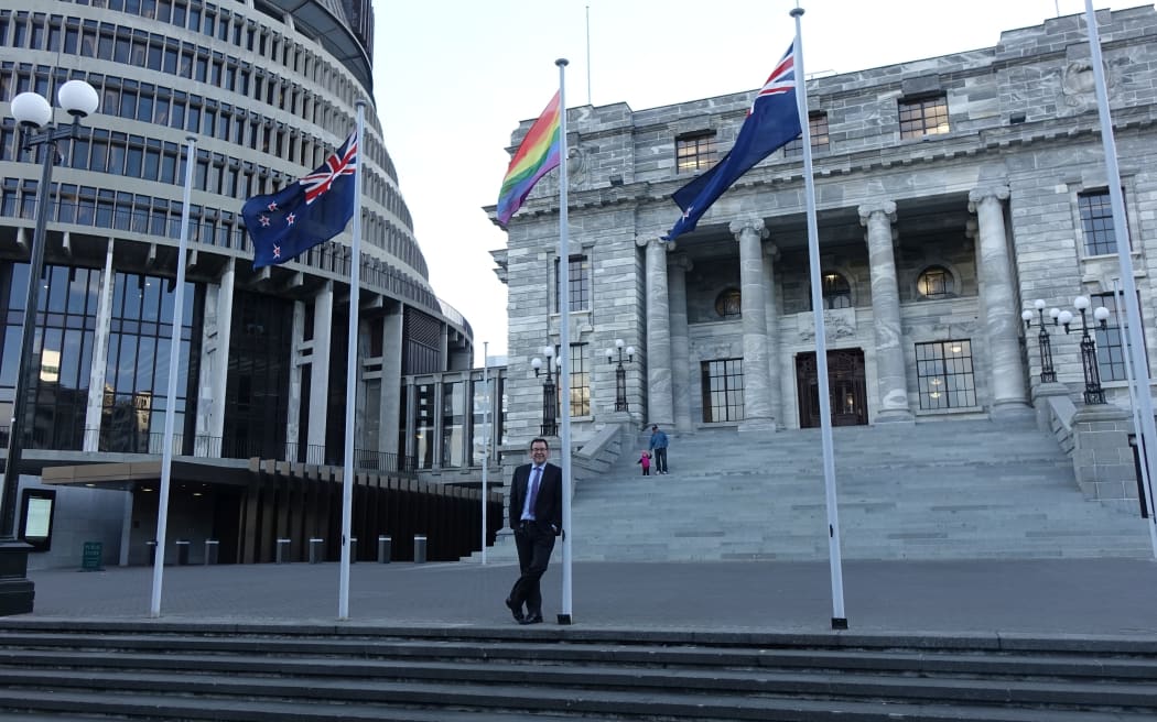 Labour MP Grant Robertson beneath a rainbow flag flying in Parliament grounds July 2016.