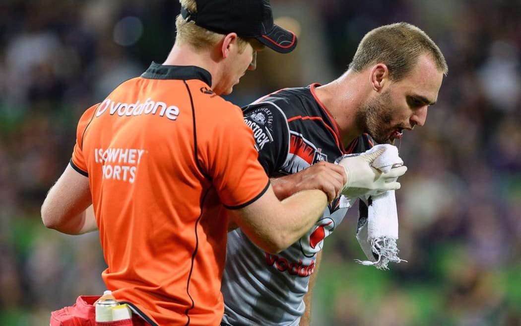 Warriors captain Simon Mannering leaves the field with a severe cut to his mouth during the NRL match against the Storm at AAMI Park in Melbourne, Australia. Anzac Day, Monday 25 April 2016. © Copyright Image: Jeff Crow / www.photosoprt.nz
