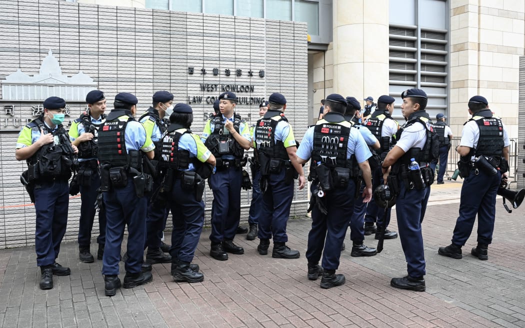 Policemen are seen outside the West Kowloon Magistrates' Court in Hong Kong on May 30, 2024, which found 14 people guilty of subversion in the biggest case against pro-democracy campaigners since China imposed a national security law to crush dissent. The 14, along with 31 others who pleaded guilty, could face life in jail, with sentencing expected later this year. (Photo by Peter PARKS / AFP)